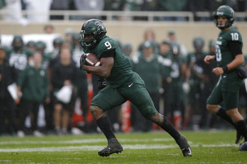 Michigan State's Kenneth Walker III (9) runs for a touchdown against Michigan during an NCAA college football game, Saturday, Oct. 30, 2021, in East Lansing, Mich. (AP Photo/Al Goldis)