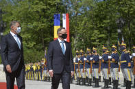 Polish President Andrzej Duda, right, reviews the honor guard with Romanian President Klaus Iohannis during the welcoming ceremony at the Cotroceni presidential palace in Bucharest, Romania, Monday, May 10, 2021. (AP Photo/Alexandru Dobre)