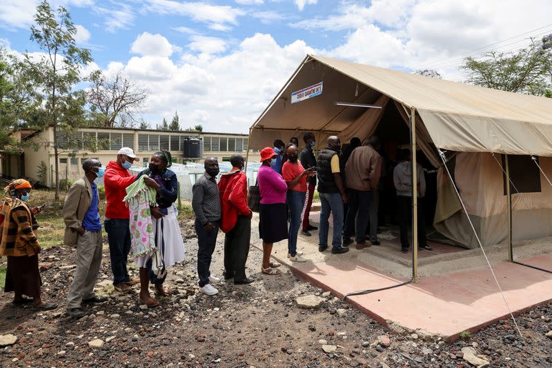 FILE PHOTO: People stand in line to receive COVID-19 vaccine, in Narok