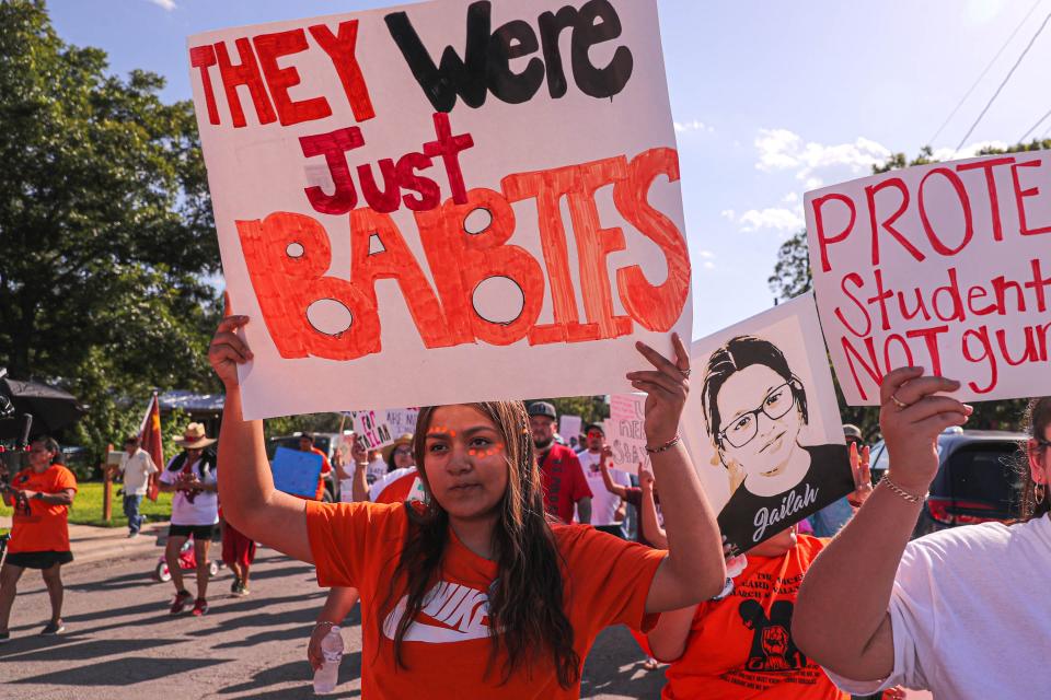 Kaitlynn Luevanos carries a sign in Uvalde, Texas on July 10, 2022. Hundreds took to the streets of Uvalde late Sunday to call for transparency in the investigation of the Uvalde Police response to the May mass shooting at Robb Elementary and to call for more gun reform.