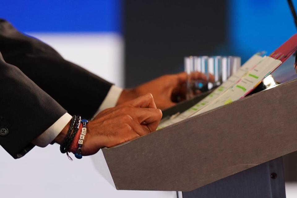 A close-up of a Dada bracelet worn by Rishi Sunak as he looks at his notes during the BBC Leadership debate at Victoria Hall on July 25, 2022 (Getty Images)