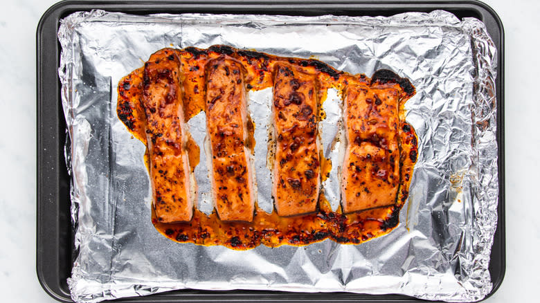 Broiled salmon on a baking sheet