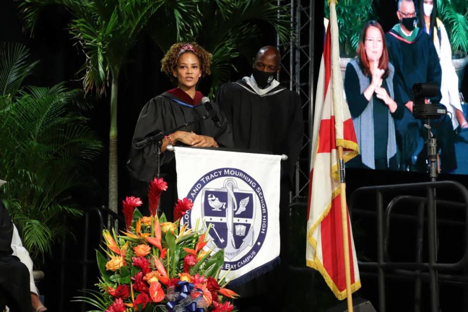 Tracy Mourning, with Alonzo Mourning looking on, addresses graduates of Alonzo and Tracy Mourning Senior High at the commencement ceremony held Tuesday, June 1, 2021, at the Ocean Bank Convocation Center at Florida International University’s main campus. 