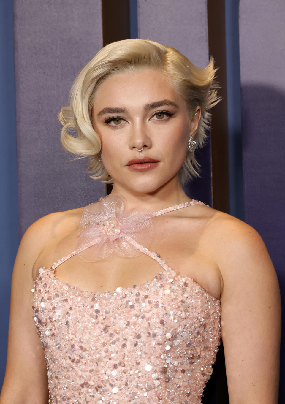 Close-up of Florence at a media event in a sparkly, strapless outfit