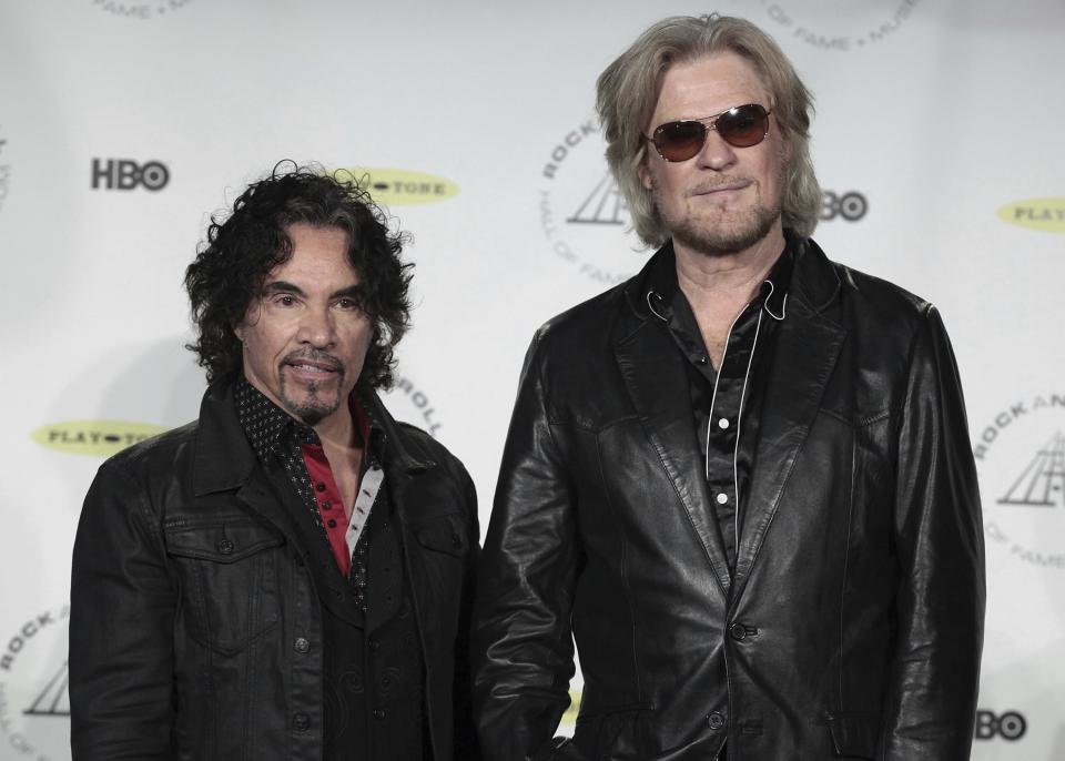 FILE - Hall of Fame Inductees, Hall & Oates, John Oates and Daryl Hall appear in the press room at the 2014 Rock and Roll Hall of Fame Induction Ceremony on April, 10, 2014, in New York. Hall has sued his longtime music partner John Oates, arguing that his plan to sell off his share of a joint venture would violate a business agreement the duo had. (Photo by Andy Kropa/Invision/AP, File)