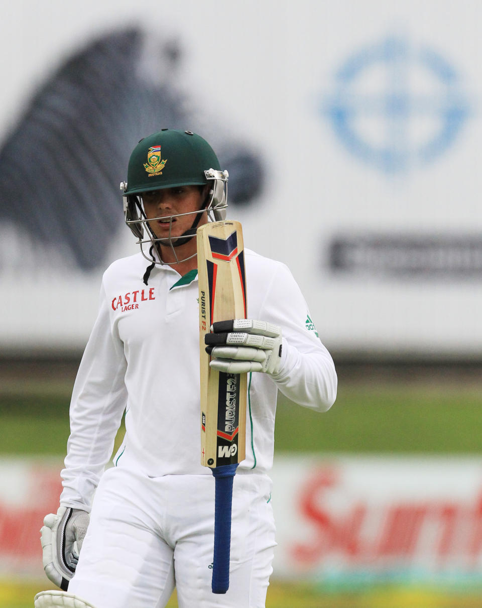 South Africa's batsman Quinton de Kock, walks back to the players pavilion after being dismissed by Australia's Steven Smith, for 7 runs on the first day of their 2nd cricket test match at St George's Park in Port Elizabeth, South Africa, Thursday, Feb. 20, 2014. (AP Photo/ Themba Hadebe)