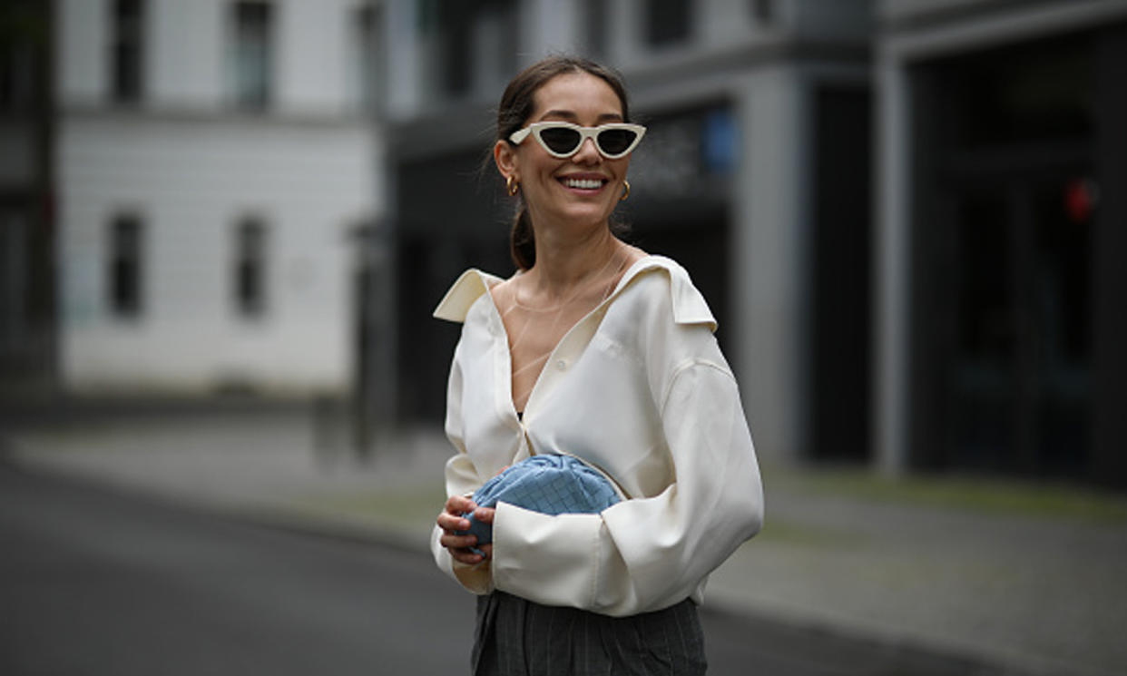 Woman wearing button up top and trousers