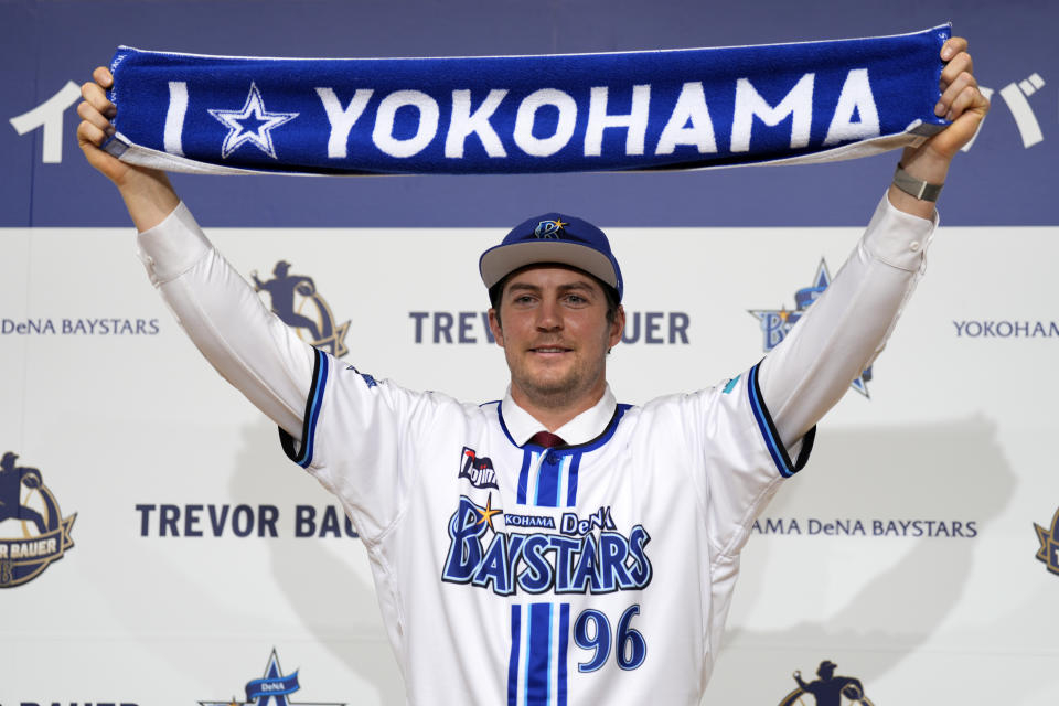 FILE - Trevor Bauer with his new uniform and cap of the Yokohama DeNA BayStars poses for photographers during a photo session of the news conference on March 24, 2023, in Yokohama, near Tokyo. Bauer is pitching his first official game for the BayStars on Wednesday, May 2. (AP Photo/Eugene Hoshiko, File)