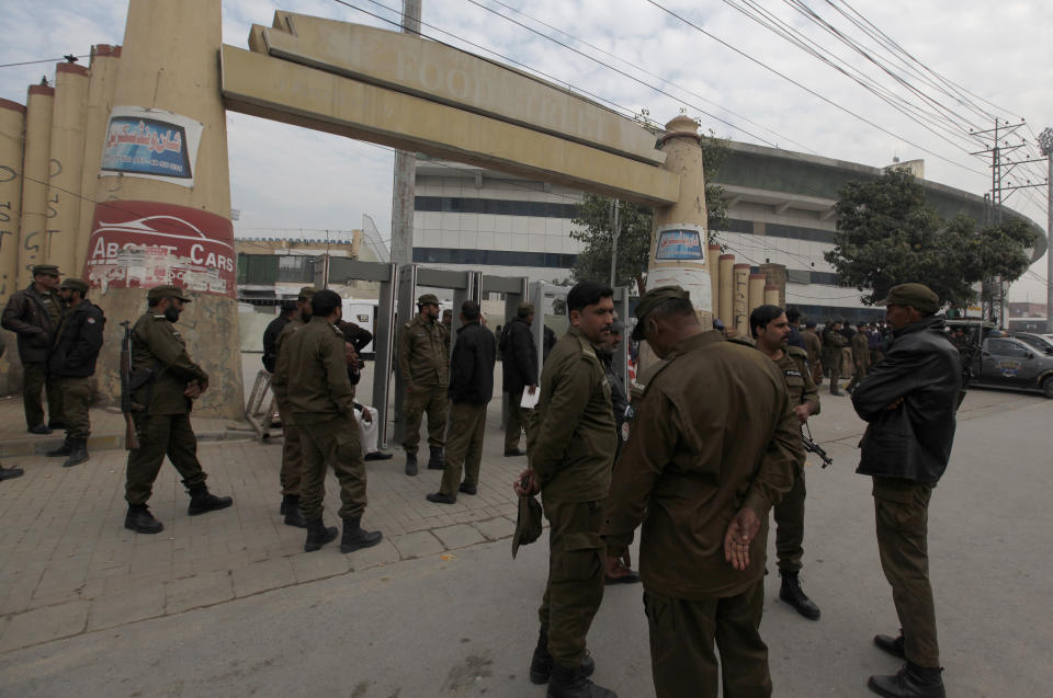 Police officers take positions outside the Pindi Cricket stadium to ensure security ahead of first test match between Pakistan and Sri Lankan cricket teams in Rawalpindi, Pakistan, Monday, Dec. 9, 2019. Sri Lanka's cricket team arrived in Pakistan to play two-test series that will be the first tests in Pakistan in over a decade. Sri Lanka was the last team to play a test match in Pakistan in 2009 before the team came under terrorist attack at Lahore and the doors to international cricket were closed on Pakistan. (AP Photo/Anjum Naveed)