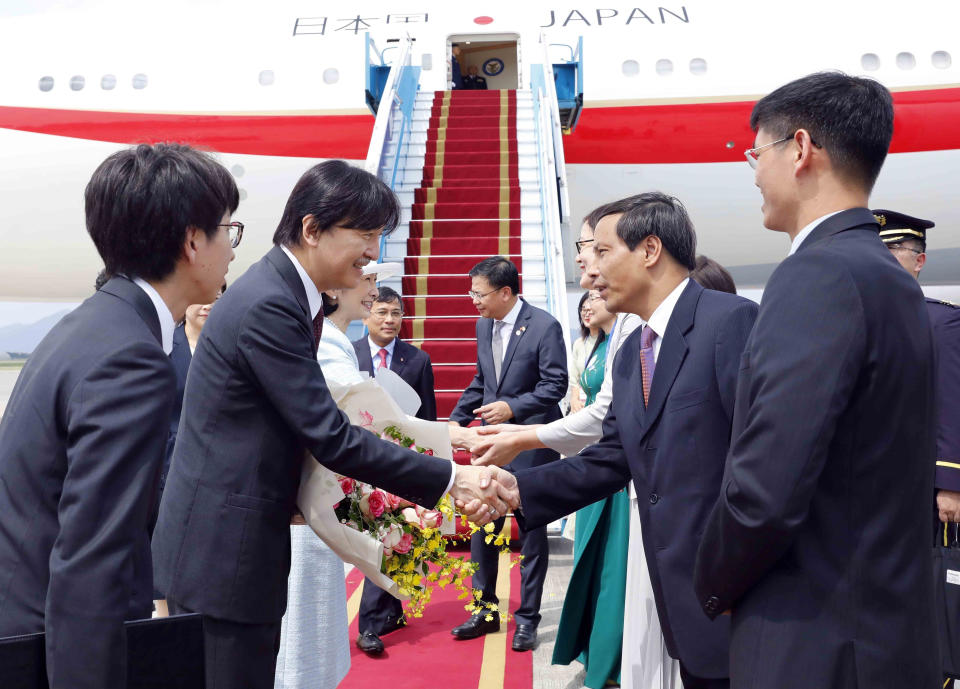 Japanese Crown Prince Akishino, second left, and Crown Princess Kiko, third left, shake hands with Vietnamese officials after landing in Hanoi, Vietnam Wednesday, Sept. 20, 2023. They are on a visit to Vietnam to mark the 50th anniversary of the diplomatic relation between the two countries. (An Van Dang/VNA via AP)