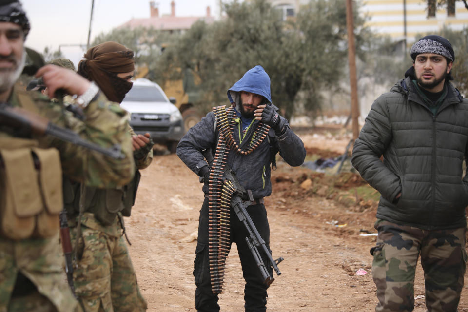 Turkish backed Syrian fighters prepare to go to frontline in Idlib province, Syria. Tuesday, Feb. 11, 2020. The fighting on Tuesday concentrated near the village of Nairab as rebels, with the backing of Turkish artillery, tried to retake the village that they lost last week, according to opposition activists. (AP Photo/Ghaith Alsayed)