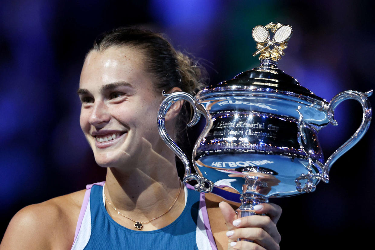 Belarus' Aryna Sabalenka poses with the trophy after winning against Kazakhstan's Elena Rybakina during the women's singles final on day thirteen of the Australian Open tennis tournament in Melbourne on January 28, 2023. (Photo by Martin KEEP / AFP) / -- IMAGE RESTRICTED TO EDITORIAL USE - STRICTLY NO COMMERCIAL USE --