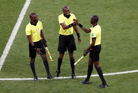 Soccer Football - World Cup - Round of 16 - Belgium vs Japan - Rostov Arena, Rostov-on-Don, Russia - July 2, 2018 Referee Malang Diedhiou with his assistants REUTERS/Murad Sezer