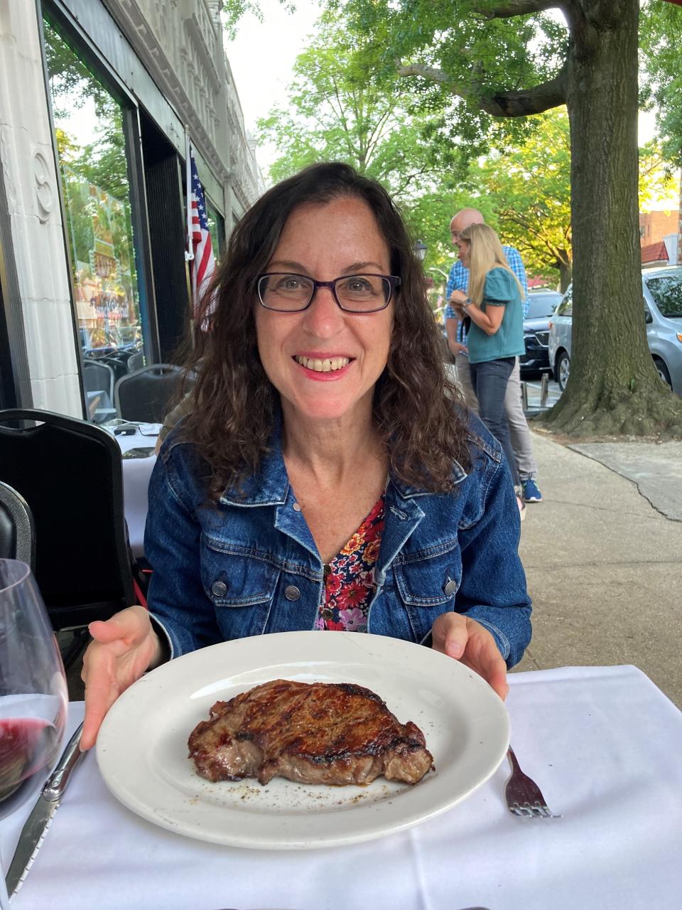 Lohud Food & Dining Reporter Jeanne Muchnick with steak from Macelleria Italian Steakhouse in Pelham. Photographed June 2022.