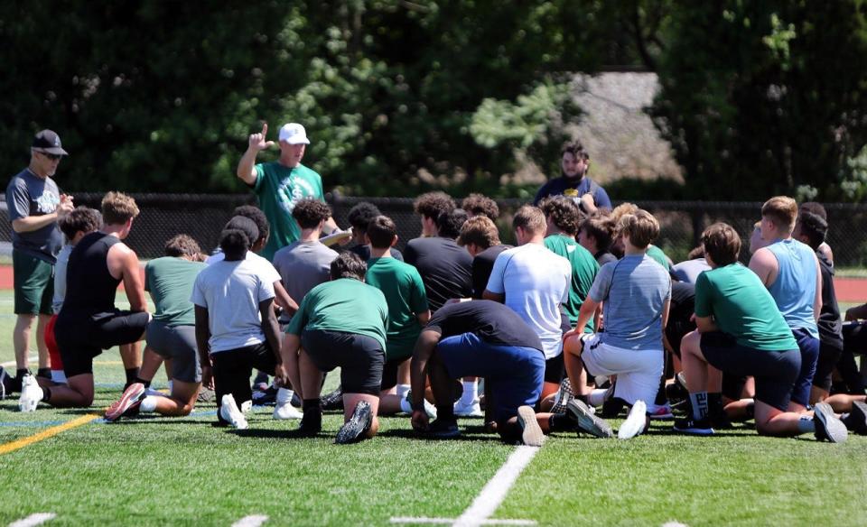 Saint Joseph football coach Bill Tracy addresses his players.