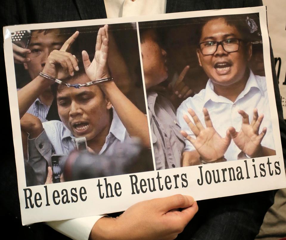 A protester holds a placard outside the Myanmar consulate in Hong Kong after a Myanmar court sentenced two Reuters journalists to seven years in prison. (Photo: ASSOCIATED PRESS)