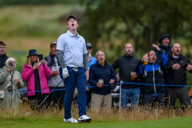 Robert MacIntyre and fans react with disappointment to a missed putt