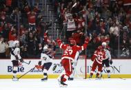 Detroit Red Wings defenseman Moritz Seider (53) celebrates an overtime goal by Patrick Kane against the Columbus Blue Jackets in an NHL hockey game Tuesday, March 19, 2024, in Detroit. (AP Photo/Duane Burleson)