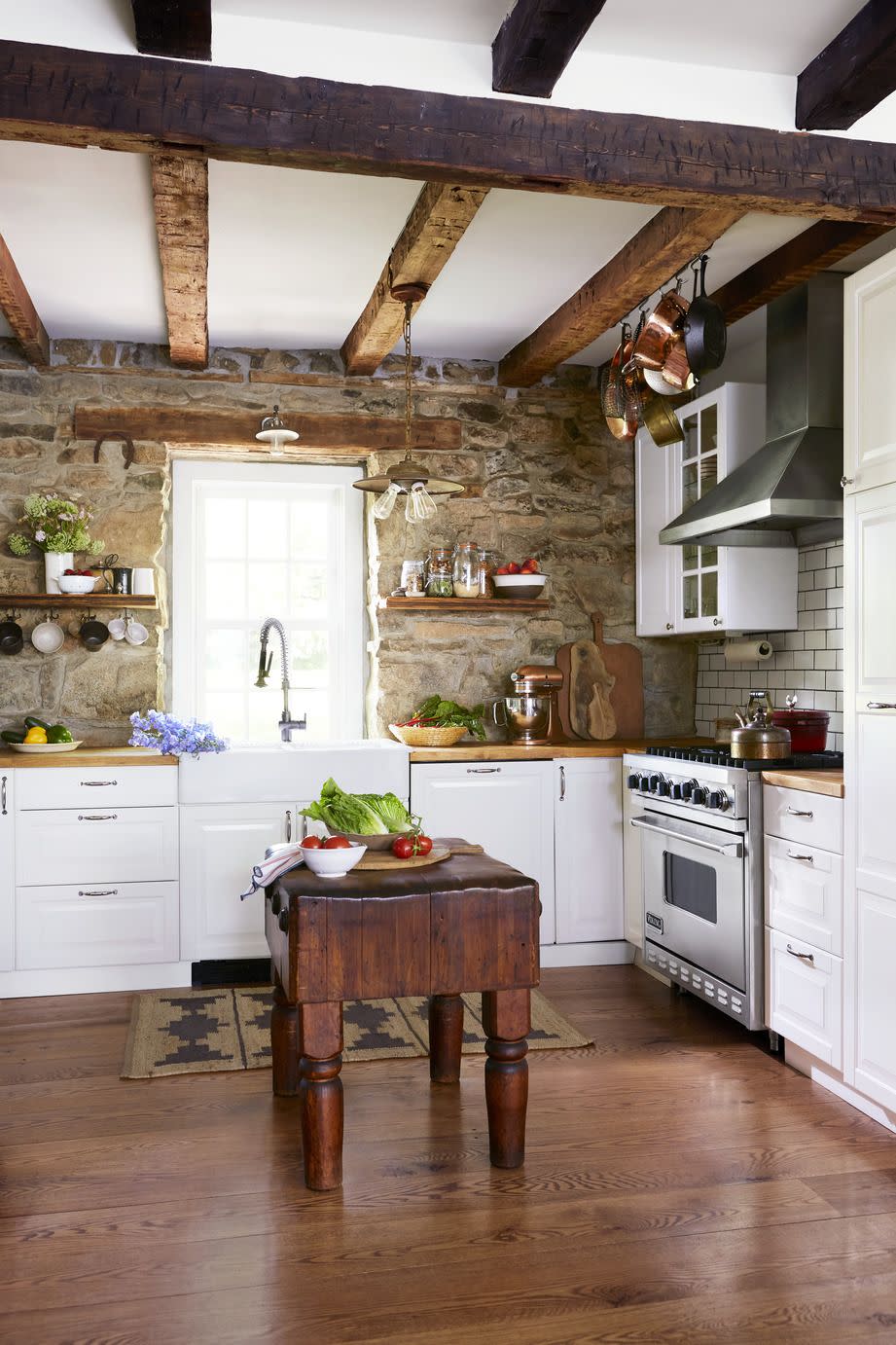 Stone Walls and Beams in a White Kitchen