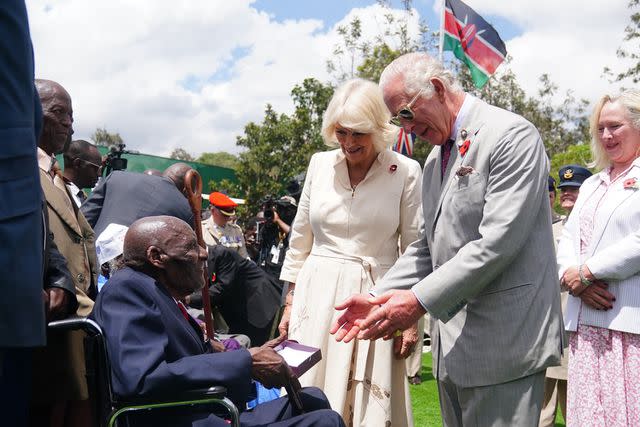 <p>Victoria Jones/Getty</p> King Charles and Queen Camilla meet veteran Samwel Nthigai Mburia on Nov. 1, 2023 in Nairobi, Kenya