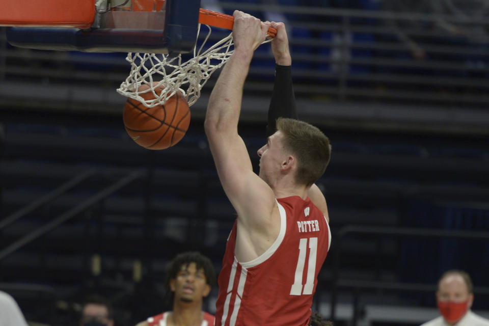 Wisconsin's Micah Potter (11) goes up for a dunk against Penn State during the second half of an NCAA college basketball game, Saturday, Jan. 30, 2021, in State College, Pa. (AP Photo/Gary M. Baranec)