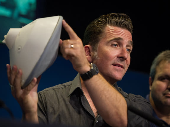 Adam Steltzner, NASA's Mars Science Laboratory entry, descent and landing phase lead, holds a model of the spacecraft during a briefing at the Jet Propulsion Laboratory Aug. 2, 2012 in Pasadena, Calif. The spacecraft will land the 1-ton rover C