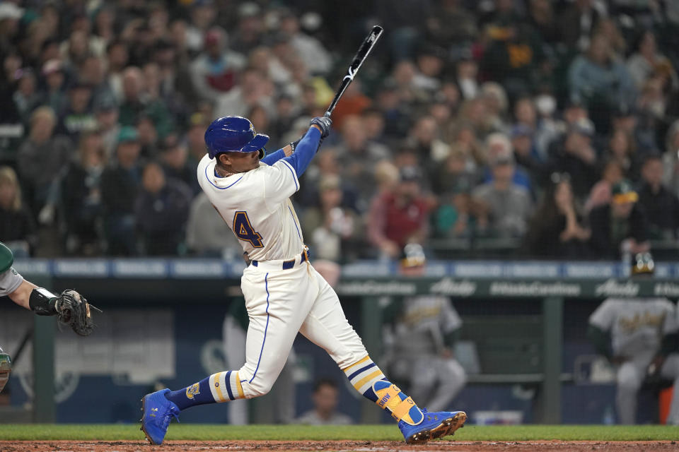 Seattle Mariners' Julio Rodriguez hits an RBI double to score Dylan Moore during the sixth inning of a baseball game against the Oakland Athletics, Sunday, July 3, 2022, in Seattle. (AP Photo/Ted S. Warren)