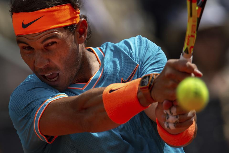 Rafael Nadal, from Spain, returns the ball to Felix Auger-Aliassime, from Canada, during the Madrid Open tennis tournament in Madrid, Wednesday, May 8, 2019. (AP Photo/Bernat Armangue)