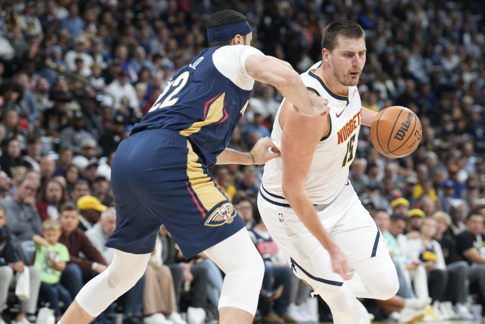 Denver Nuggets center Nikola Jokic, right, drives past New Orleans Pelicans forward Larry Nance Jr., left, in the first half of an NBA basketball game Monday, Nov. 6, 2023, in Denver. (AP Photo/David Zalubowski)