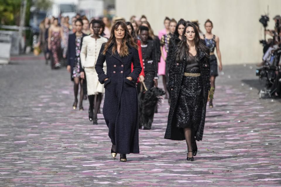 Caroline de Maigret, left, leads other models as they wear creations for the Chanel Haute Couture Fall/Winter 2023-2024 fashion collection presented in Paris, Tuesday, July 4, 2023. (AP Photo/Christophe Ena)