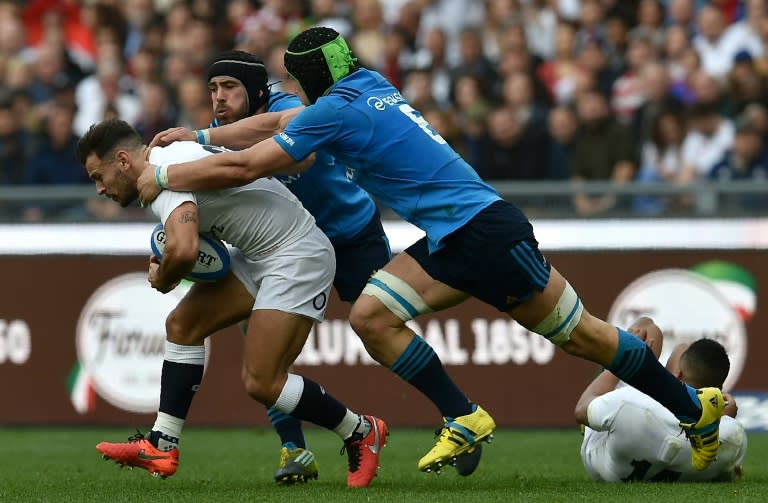 England's scrum half Danny Care (L) is tackled by Italy players during the Six Nations match in Rome on February 14, 2016