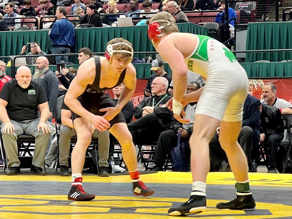 Pleasant's Daxton Chase, left, squares off with Barnesville's Reese Stephen in the Division III 150-pound state wrestling tournament championship bout Sunday night at Ohio State's Schottenstein Center.
