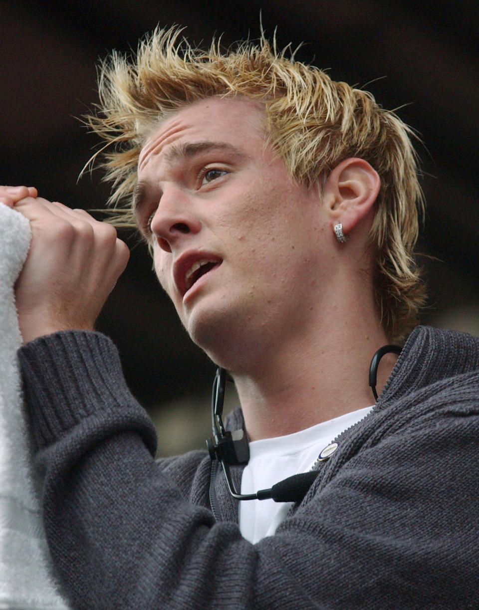 FILE - Singer Aaron Carter sings to a crowd during a First Night celebration at Government Center, on Dec. 31, 2004, in Boston. Carter, the singer-rapper who began performing as a child and had hit albums starting in his teen years, was found dead Saturday, Nov. 5, 2022, at his home in Southern California. He was 34. (AP Photo/Lisa Poole, File)