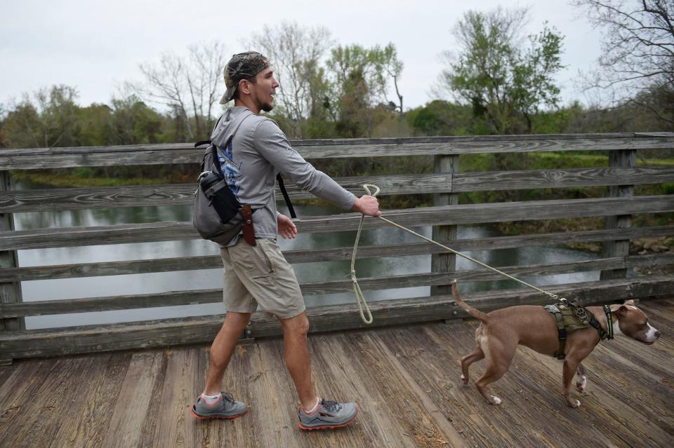 Michael Dick, of Augusta, and his dog Bella go for a walk at Augusta Canal Trail.