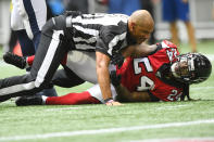 Referee Terry McAulay (77) breaks up an altercation between Atlanta Falcons running back Devonta Freeman (24) and Los Angeles Rams defensive tackle Aaron Donald during the second half of an NFL football game, Sunday, Oct. 20, 2019, in Atlanta. (AP Photo/John Amis)
