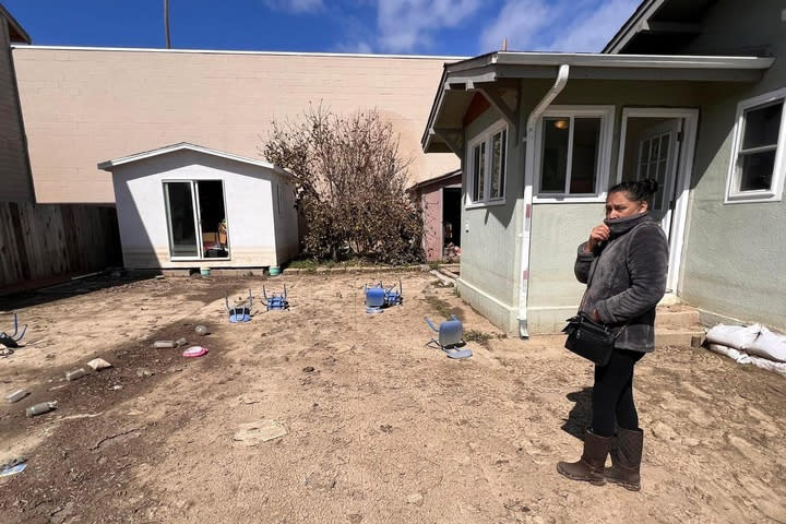 Maria Urbieta reviews the outside of her home where there was once a fence in Pajaro, Calif., on March 23, 2023. (Courtesy Luis Alejo)