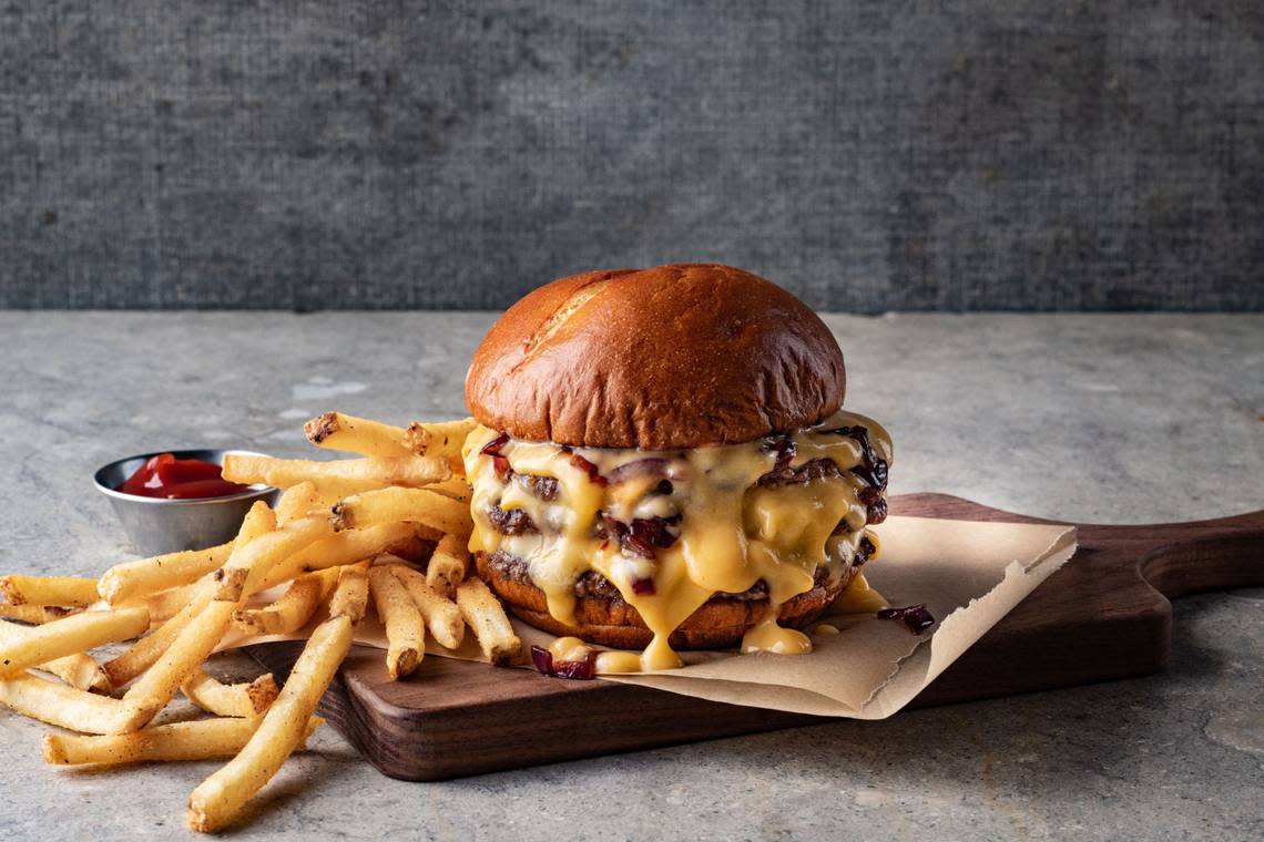 The Triple Lava burger at the new Family Kitchen has three hand-smashed patties topped with American cheese, then smothered in cheese sauce and finished with caramelized onions