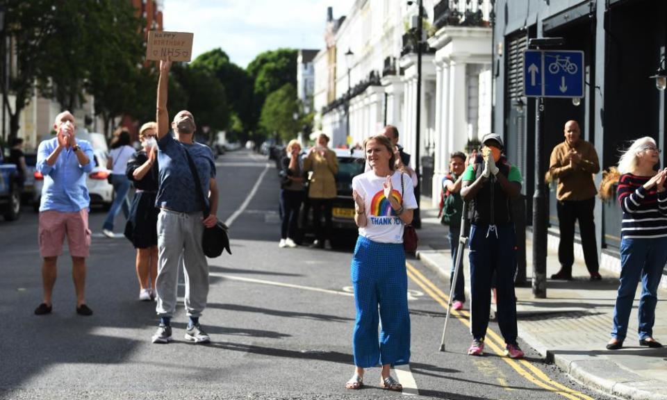 People clap for the NHS outside a London hospital.