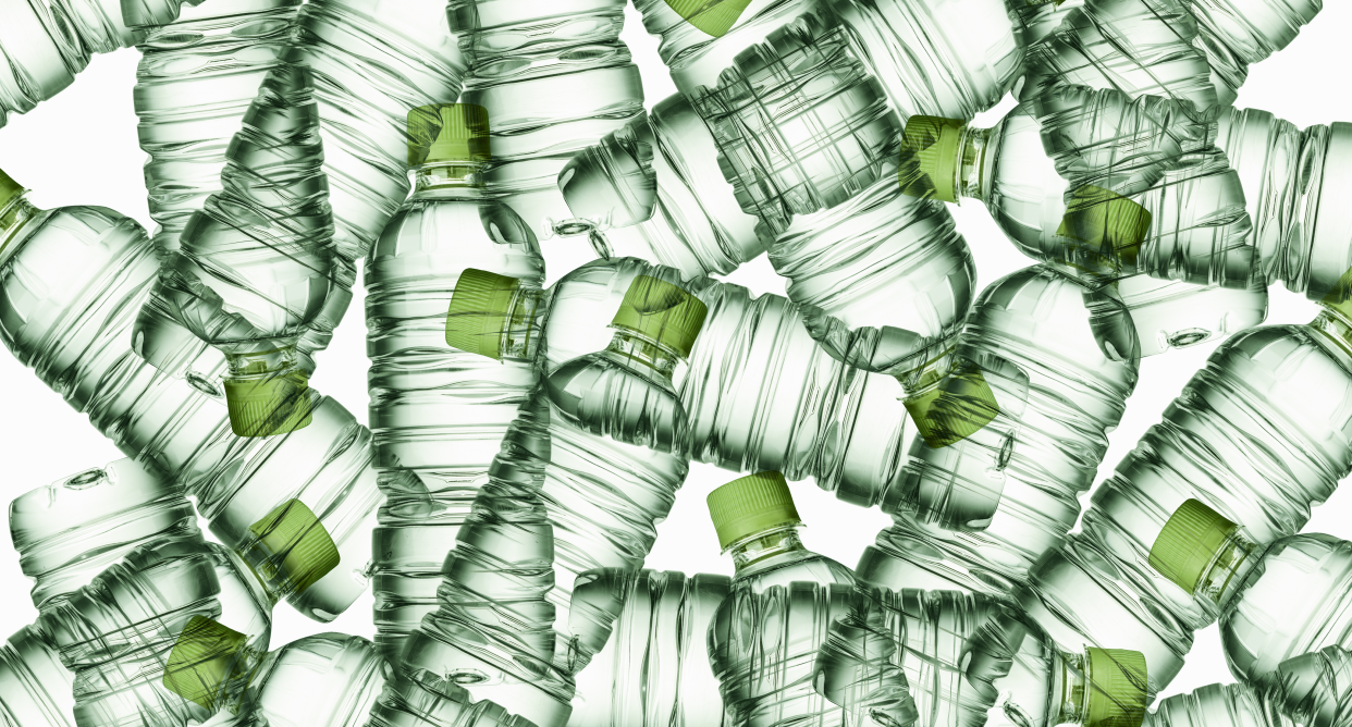 Green plastic bottles on a light white background