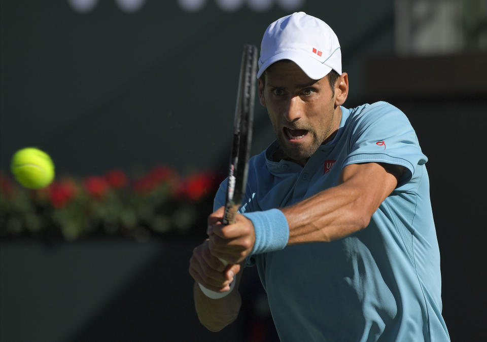 Novak Djokovic, of Serbia, returns a shot to Nick Kyrgios, of Australia, at the BNP Paribas Open tennis tournament, Wednesday, March 15, 2017, in Indian Wells, Calif. (AP Photo/Mark J. Terrill)