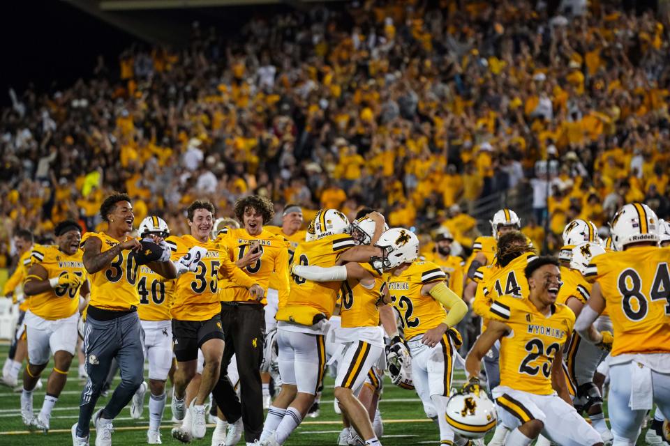 Wyoming fans rush the field to celebrate with their team after the Cowboys upset Texas Tech 35-33 in double overtime Saturday in Laramie, Wyoming. The Red Raiders host Oregon at 6 p.m. Saturday.