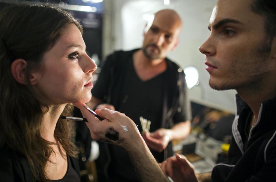 Model Lauren English looks to makeup artist Alyx Bilser, right, backstage before the Jill Stuart 2014 collection is modeled during Fashion Week in New York, Saturday, Sept. 7, 2013. (AP Photo/Craig Ruttle)