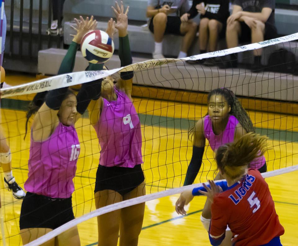 Cedar Park Timberwolves middle blocker Sienna Benavidas (16) blocks the shot by Leander Lions outside hitter Jacey Moulton (5) during the third set at the District 25-5A volleyball game on Tuesday, October 17, 2023, at Cedar Park High School - Cedar Park, TX.