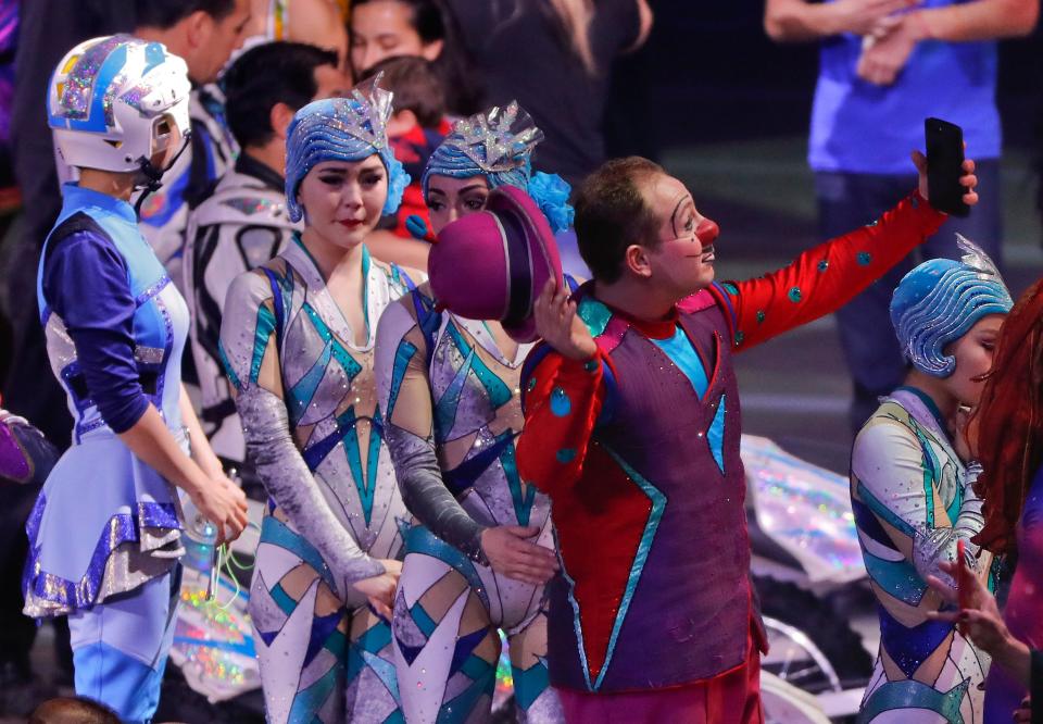 A clown holds up his cell phone to record the end of the final show of the Ringling Bros. and Barnum & Bailey Circus on May 21, 2017 in Uniondale, N.Y. Feld Entertainment is developing plans to to resume circus operations without animals in 2023.