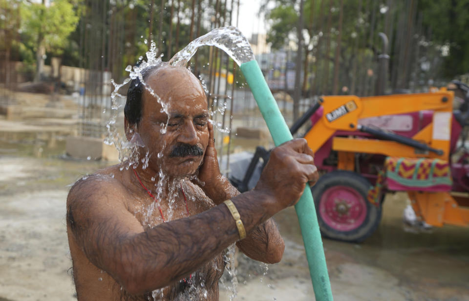 An Indian worker bathes at a building construction site as he tries to cool off on a hot day in Prayagraj, northern Uttar Pradesh state India, Monday, May 22, 2023. The heat wave in the state is likely to continue for another two days, an Indian Meteorological Department official said. (AP Photo/Rajesh Kumar Singh)