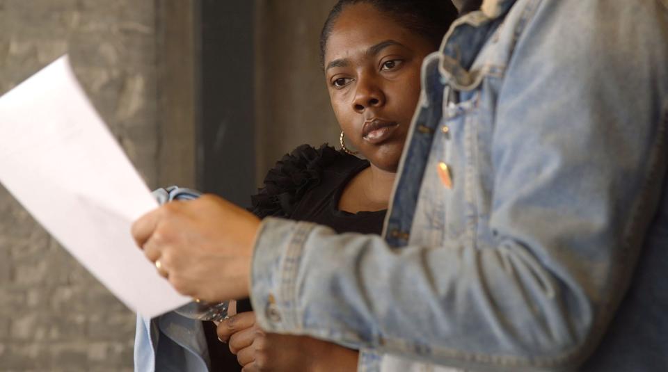 Thor Jones, right, helps guide Markeisha Wesley on proper table setup at Freya during a Full Hands In Full Hands Out class on March 30, 2022. The class gives students the tools they need to gain employment in the restaurant industry.