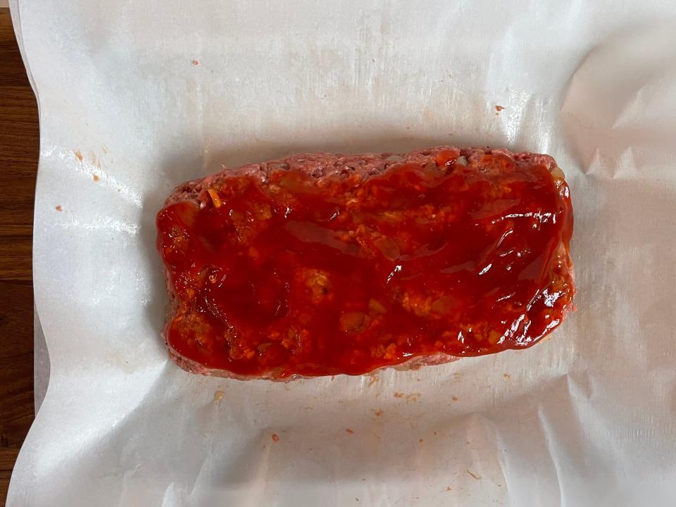 Shaped meat loaf with ketchup on top.