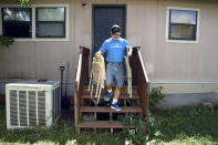 ADVANCE ON THURSDAY, SEPT. 12 FOR USE ANY TIME AFTER 3:01 A.M. SUNDAY SEPT 15 Mark Robbins removes lawn chairs from his home at the Orchard Grove Mobile Home Park in Boulder, Colo., on Monday, Aug. 26, 2019. Robbins, who moved to the park in 1982 and is a member of the neighborhood association, says residents have been subjected to illegal evictions and onerous rules since the park was sold in 2015. (AP Photo/Thomas Peipert)