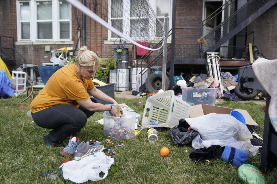 Kristen Bigogno gathers up some of her belongings while being evicted from her home Friday, Sept. 17, 2021, in St. Louis. Bigogno is among thousands of Americans facing eviction now that the national moratorium has ended. (AP Photo/Jeff Roberson)
