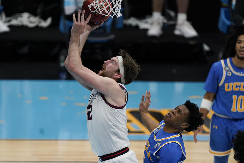 Gonzaga forward Drew Timme, left, shoots ahead of UCLA guard Jaylen Clark, right, during the second half of a men's Final Four NCAA college basketball tournament semifinal game, Saturday, April 3, 2021, at Lucas Oil Stadium in Indianapolis. (AP Photo/Michael Conroy)